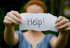 Wife holding up "Help!" sign